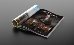 An open magazine on a gray surface features a 