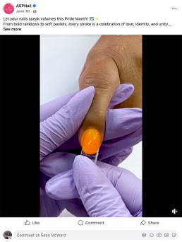 A gloved hand applies glossy orange nail polish to a person's fingernail, celebrating Pride Month. The scene evokes creativity and inclusivity.