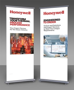 Two vertical Honeywell banners. Left: Emphasizes thermal process performance with glass bottles image. Right: Highlights engineered solutions with two men at monitors.